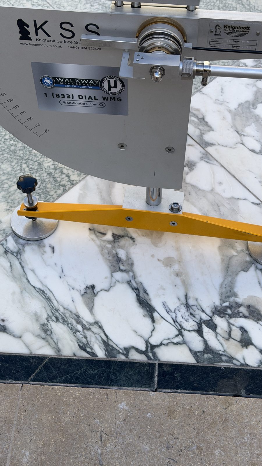Close-up of the pendulum slider contacting a marble specimen