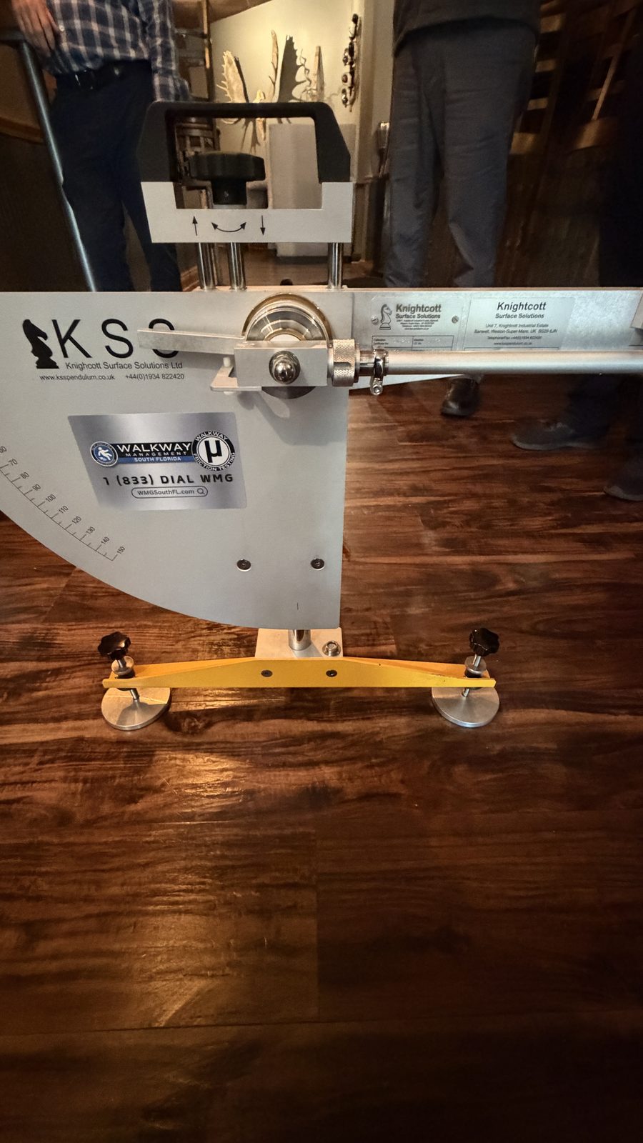 Pendulum Slip Tester on a dark polished wood restaurant floor