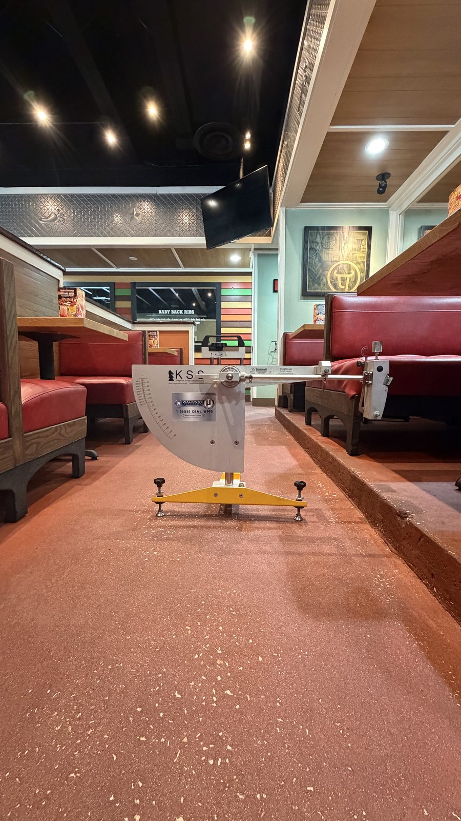 Pendulum Slip Tester on a restaurant dining room floor