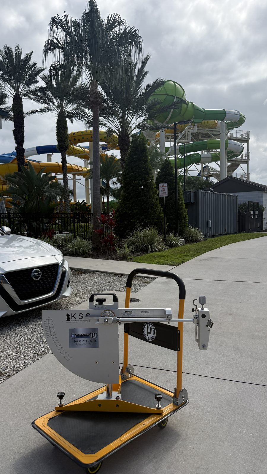 Pendulum Slip Tester at a waterpark with slides in the background