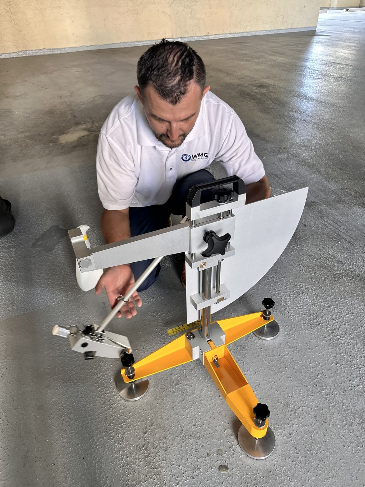 Walkway Management technician running a pendulum slip test on a client floor